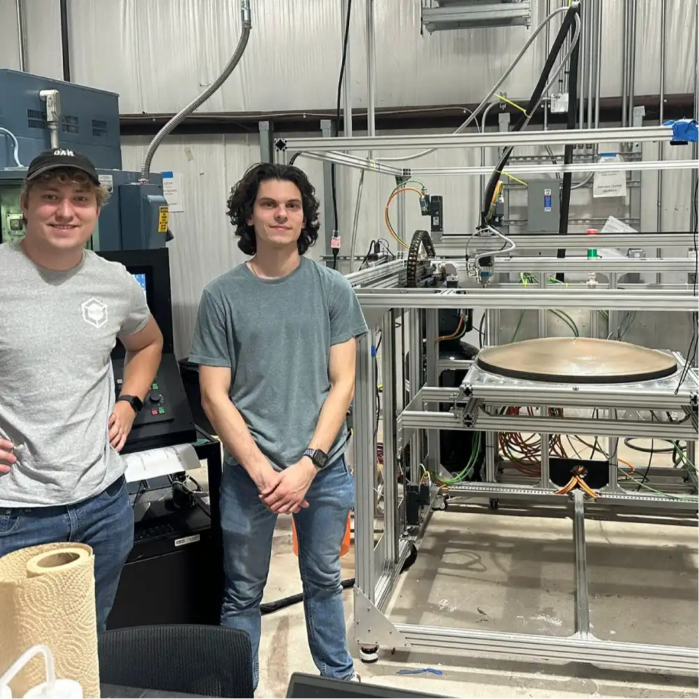 Figure: re:3D engineers Eric Gohl and Will Drakas after the successful conformal printing of a 750-mm dish TPS structure.